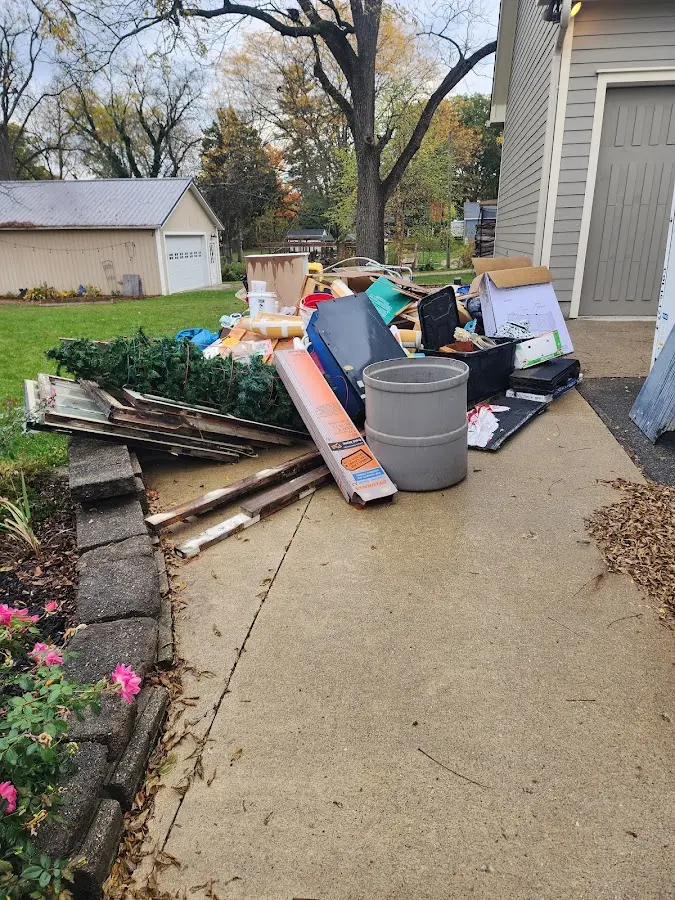 Dumpster being loaded with debris for 12 Yard Dumpster Rental in Artesia